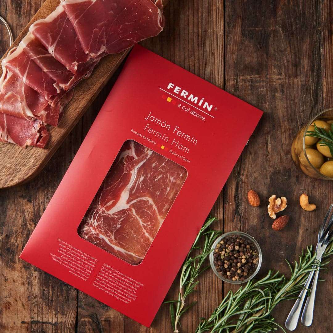 a package of jamon serrano on a wooden table