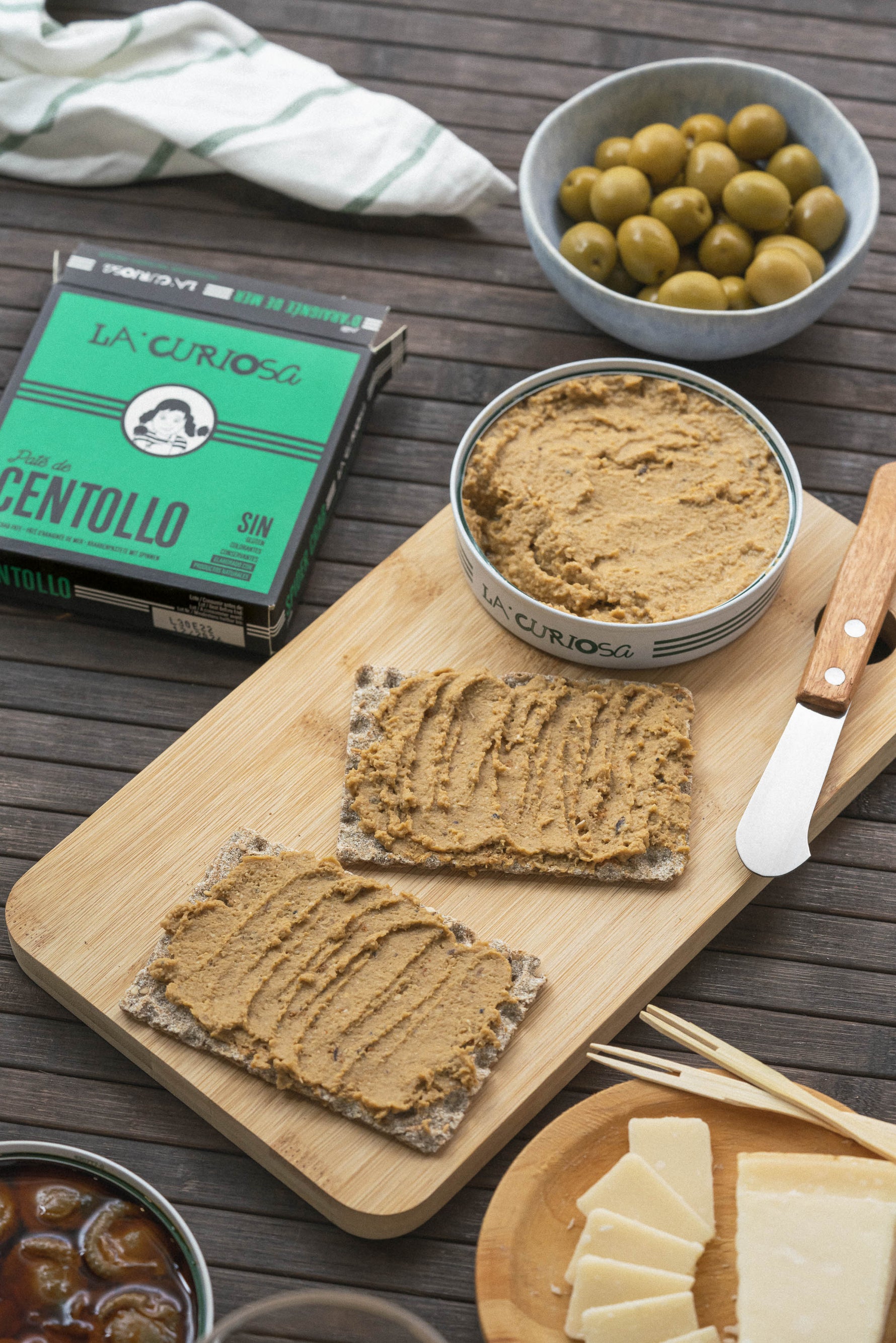 king crab spread on crackers with olives