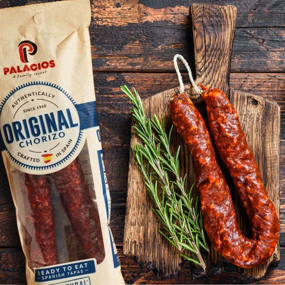 a chorizo sausage on a board with rosemary